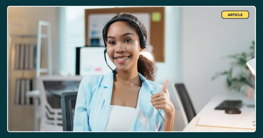 A happy call centre agent smiling with her thumb up