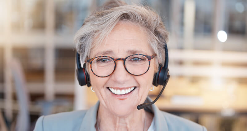 Happy mature call centre worker smiling