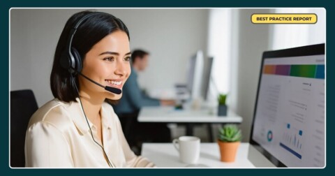 Smiling call centre agent at a computer desk